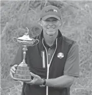  ?? ASHLEY LANDIS/AP ?? Team USA captain Steve Stricker poses with the trophy after the Americans won the Ryder Cup on Sunday at Whistling Straits Golf Course in Sheboygan, Wis.