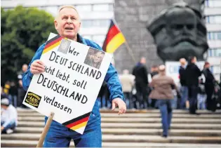  ?? PHOTO: REUTERS ?? Firm views . . . A demonstrat­or of the farright ‘‘Pro Chemnitz’’ group holds a placard reading ‘‘Whoever does not love Germany, should leave Germany’’ in Chemnitz, Germany..