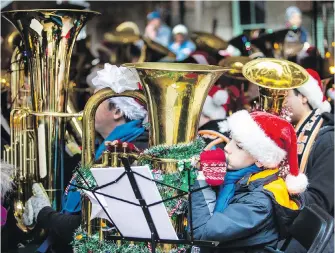  ?? DARREN STONE, TIMES COLONIST ?? Nicky Begley, 11, was among the 100-plus musicians performing at Tuba Christmas in Market Square on Saturday.