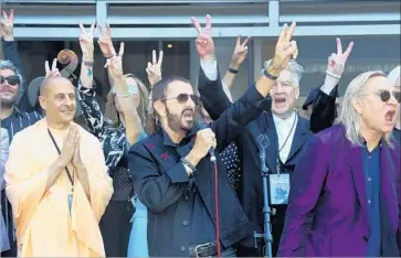  ?? Rick Loomis Los Angeles Times ?? IT’S AN ANNUAL tradition now. Ringo Starr, center, and friends gathered Friday to wish for peace and love.