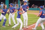  ?? Gene J. Puskar / Associated Press ?? Michigan pitcher Jakob Furkas (18) celebrates with teammates after the final out in the team’s 2-1 win over Honolulu at the Little League World Series in South Williamspo­rt, Pa., on Saturday.