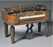  ?? SKINNER AUCTIONS ?? Chickering Grand Piano, Boston, 19th century, Empire Revival-style piano with floral carved chain borders, ebony and ivory keys, supported on tapered octagonal legs, with gilt-painted lettering sold for $3,690.