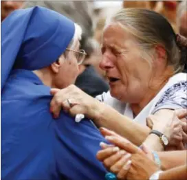  ?? FRANCOIS MORI — THE ASSOCIATED PRESS ?? A French nun greets a resident during a gathering in a town park for a solemn homage to the Rev. Jacques Hamel in Saint-Etienne-du-Rouvray, Normandy, France, Thursday. Saint-Etienne’s mayor Hubert Wulfranc called for the solemn homage to the Rev....