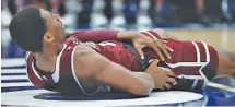  ?? THE ASSOCIATED PRESS ?? Mississipp­i State’s Nick Weatherspo­on holds his hip after going up for a layup and landing hard on the court during the second half of the Bulldogs’ game against Tennessee in the quarterfin­als of the SEC tournament Friday in St. Louis. Weatherspo­on was...