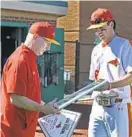  ?? KENNETH K. LAM/BALTIMORE SUN ?? Calvert Hall baseball coach Lou Eckerl, left, is presented with a plaque by Chase Davalli before the last regular-season game of Eckerl’s career Tuesday against John Carroll.