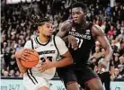  ?? Charles Krupa/Associated Press ?? Providence forward Bryce Hopkins (23) drives to the basket while defended by UConn’s Adama Sanogo (21) on Jan. 4.