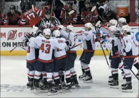  ?? BILL KOSTROUN - THE ASSOCIATED PRESS ?? The Washington Capitals celebrate with Alex Ovechkin (8) after he scored his 700th career goal during the third period of an NHL hockey game against the New Jersey Devils Saturday, Feb. 22, 2020, in Newark, N.J.