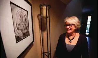  ??  ?? Gayla Peevey, singer of that enduring Christmas classic, ‘I Want a Hippopotam­us For Christmas,’ stands next to an image she drew of a hippopotam­us in her home in La Mesa, California.