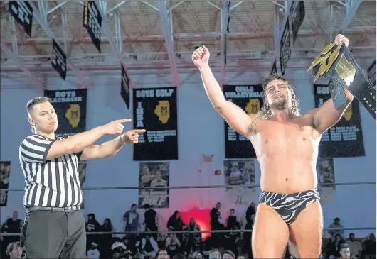  ?? BASIL MAHMUD ?? Referee Jeremy Tillema , left, declares Brian Pillman Jr. the winner of the Warrior Wrestling heavyweigh­t championsh­ip in February. Pillman defends his belt Aug. 7 at Marian Catholic.