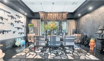  ?? REALTOR.COM PHOTOS ?? Remodeled after Dr. Phil bought the 6,170-sq.-ft. house in 2007, the dining room has a bizarre, gun-lined wall.