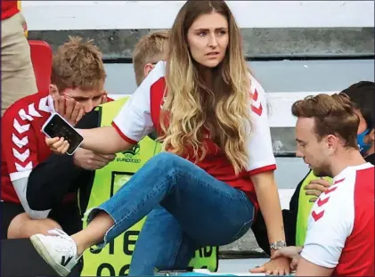  ??  ?? HORROR: Sabrina Kvist Jensen, above, the partner of Christian Eriksen, jumps on the pitch after his collapse