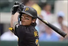  ?? Charlie Neibergall/Associated Press ?? Pirates’ Ji Hwan Bae watches a found ball in the fifth inning Saturday against the Tigers in Lakeland, Fla.