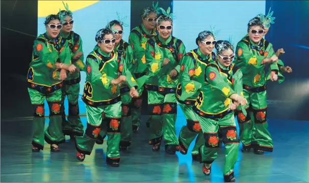  ?? GAO ERQIANG / CHINA DAILY ?? Carnation, a square dancing team formed by retirees, performs at the Looking For China’s Most Beautiful Queen of Square Dancing competitio­n in Shanghai last year. Yang Suxian, 64, one of the founders of Carnation, an amateur square dancing troupe