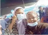  ??  ?? Hajiya Rafat Idris Salami with a Christian sister during the breaking of fast at Al-Habibiyah Mosque, Guzape, Abuja