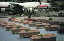  ?? Peter Lauth / AP Photo ?? The coffins of 36 Swiss victims of the 1997 massacre in Luxor, Egypt, lined up in a hangar at Zurich airport.