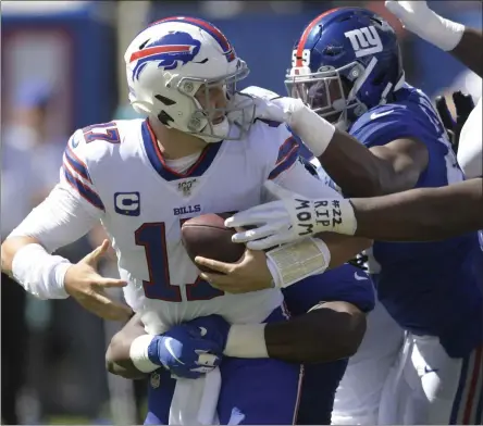  ?? BILL KOSTROUN - THE ASSOCIATED PRESS ?? Buffalo Bills quarterbac­k Josh Allen, left, is sacked during the first half of an NFL football game against the New York Giants, Sunday, Sept. 15, 2019, in East Rutherford, N.J.