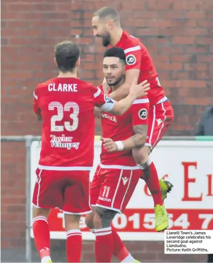  ??  ?? Llanelli Town’s James Loveridge celebrates his second goal against Llandudno. Picture: Keith Griffiths.