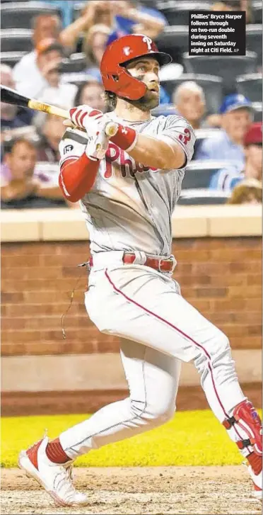  ?? AP ?? Phillies’ Bryce Harper follows through on two-run double during seventh inning on Saturday night at Citi Field.