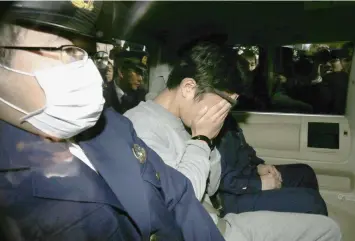  ?? (AFP) ?? Suspect Takahiro Shiraishi (C) covers his face with his hands as he is transporte­d to the prosecutor's office from a police station in Tokyo on November 1, 2017.