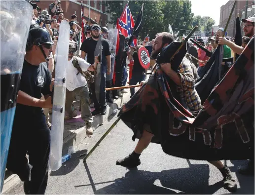  ?? (Reuters) ?? WHITE SUPREMACIS­TS clash with counter-protesters at a rally in Charlottes­ville, Virginia, over the weekend.