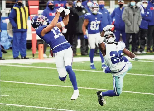  ?? Corey Sipkin / Associated Press ?? The Giants’ Dante Pettis makes a catch in front of the Cowboys’ Xavier Woods during Sunday’s game in East Rutherford, N.J.