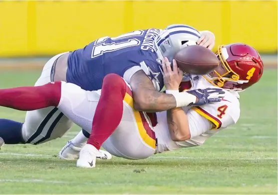  ?? ALEX BRANDON/AP ?? Taylor Heinicke fumbles as he’s sacked by Cowboys linebacker Micah Parsons. Duran Armstrong scooped up the ball and ran 37 yards for a touchdown.