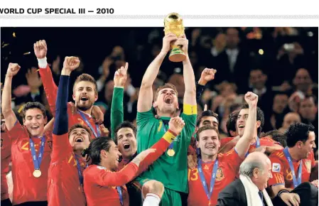  ?? AFP ?? Jubilation: Members of the victorious Spain team with the World Cup.