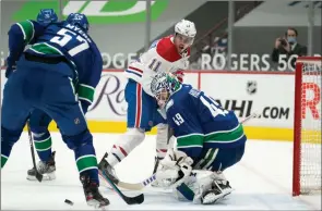  ?? The Canadian Press ?? Vancouver Canucks goaltender Braden Holtby stops Montreal Canadiens right-wing Brendan Gallagher during third-period NHL action in Vancouver, Wednesday night.