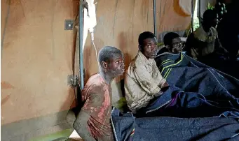  ?? AP ?? Rescued artisanal miners sit in a tent after rains flooded mines on the outskirts of Kadoma, west of Harare, this week.