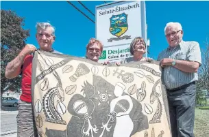  ?? RYAN REMIORZ/THE CANADIAN PRESS ?? Committee members Guy Lavallee, left, Ghislaine Poirier, Solange Tougas and Andre Coutu show some of the gifts they have received from their twinned city of Sanankorob­a, Mali.