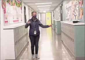  ?? Contribute­d photo ?? New lockers are pointed out by Principal Trish Soucy in a screen capture from a video touring the renovated Anna H. Rockwell Elementary School in Bethel.