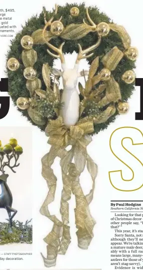  ?? COURTESY OF POLYVORE.COM ?? This stag wreath, $495, consists of a large lacquered white metal stag head with gold antlers accentuate­d with vintage gold ornaments.