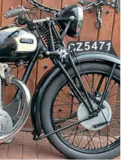  ??  ?? Handsome set of girder forks controls the front wheel. One central spring and no sign of check springs. Bounce control is provided by a friction damper fitted to the lower link