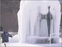  ?? LM OTERO – THE ASSOCIATED PRESS ?? City of Richardson worker Kaleb Love works to clear ice from a water fountain Feb. 16 in Richardson, Texas. Temperatur­es dropped into the single digits as snow shut down air travel and grocery stores and created havoc for high amount of residents.