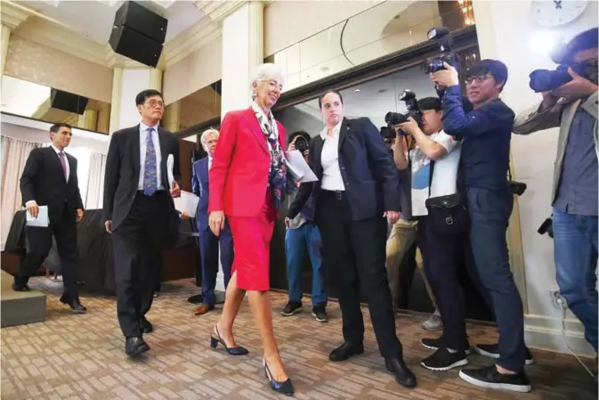  ??  ?? SEOUL: IMF managing director Christine Lagarde (center) leaves after a press conference as she wraps up her trip to South Korea in Seoul yesterday. The IMF chief warned that ageing population­s in key Asian economies will drag on their growth, urging...