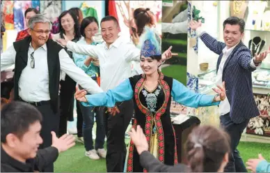  ?? MA KAI / XINHUA ?? The owner of the tourism site Guli’s Home dances with visitors in the ancient city of Kashgar in Northwest China’s Xinjiang Uygur autonomous region in May. Guli’s Home, a local resident’s yard that has been converted for tourists, has become a hot attraction for visitors who want to experience everyday life in Kashgar.