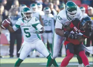  ?? The Canadian Press ?? Saskatchew­an Roughrider­s quarterbac­k Kevin Glenn (5) throws as teammate Thaddeus Coleman controls Jonathan Newsome of the Ottawa Redblacks during their CFL East Division semifinal in Ottawa last Sunday.