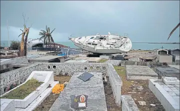  ?? AFP ?? Hurricane Irma dumps a boat in a cemetery in Marigot, SaintMarti­n island, after the powerful storm devastated the Caribbean island. Another hurricane, Jose, is expected to batter the island.