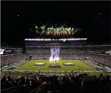  ?? TIM DONNELLY / ASSOCIATED PRESS ?? Fans watch fireworks at Lincoln Financial Field before the Eagles and Falcons kick off the NFL season on Thursday. The game was delayed by weather and finally started around 9 p.m.