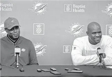  ?? SUSAN STOCKER/ SUN SENTINEL ?? Dolphins General Manager Chris Grier, left, and Coach Brian Flores have more than $90 million in cap space to work with.