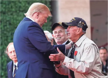  ?? IAN LANGSDON/AP ?? President Donald Trump greets a U.S. World War II veteran during a ceremony to mark the 75th anniversar­y of D-Day at the Normandy American Cemetery on Thursday. “Americans are drawn to this place,” Trump said in a speech.