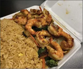  ?? (Arkansas Democrat-Gazette/Eric E. Harrison) ?? Hibachi meals, including the Hibachi Shrimp, come atop a base of mixed vegetables (zucchini, broccoli, carrot and onion) with a copious portion of “eggs fried rice” at Bamboo Hibachi on North Little Rock’s Camp Robinson Road.