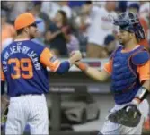  ?? BILL KOSTROUN — THE ASSOCIATED PRESS ?? Mets pitcher Jerry Blevins (39) celebrates with catcher Kevin Plawecki after they defeated the Nationals, 3-0, on Saturday in New York.