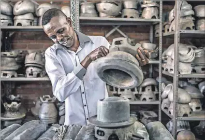  ??  ?? Pressing matter: Mabro Hats milliner Jimmy Baloyi hard at work. Photos: Mark Lewis