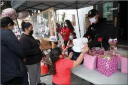  ?? PHOTO BY HOWARD FRESHMAN ?? Christian Outreach in Action volunteers distribute diapers and goodie bags to children and mothers at a Long Beach distributi­on event in honor of Mother's Day on May 7.
Daily cases