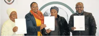  ?? Picture: ANDISA BONANI ?? HAPPY DAY: The recipients show off their title deeds after the hand-over with, from left, Ntombizodw­a Guga, Lindiwe Gunuza-Nkwentsha, Violet Guga and Nkokheli Jokozela