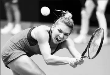  ?? — AFP photo ?? Romania’s Simona Halep hits a return against Lauren Davis of the US during their women’s singles third round match.