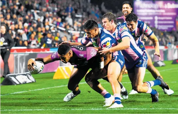  ?? Photo / Photosport ?? Scoring machine David Fusitu’a helped the Warriors see off the Knights with this try at Mt Smart on Friday night.