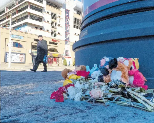  ?? AP ?? Flowers and toys lie on the ground at a makeshift memorial commemorat­ing victims of a December 30 missile attack by Ukraine in Belgorod, Russia, which has come under repeated Ukrainian shelling, and hundreds of bus stops in the city near the border with Ukraine have been reinforced with blocks of concrete and sandbags to protect them from rocket strikes.