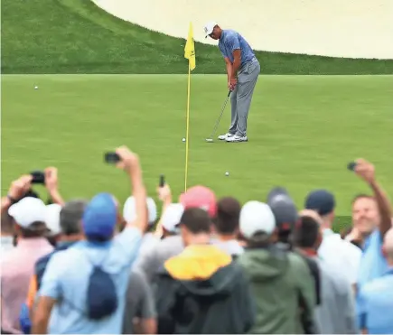  ?? ROB SCHUMACHER/USA TODAY SPORTS ?? Tiger Woods putts on the 13th green during practice Monday for the Masters tournament at Augusta National Golf Club.